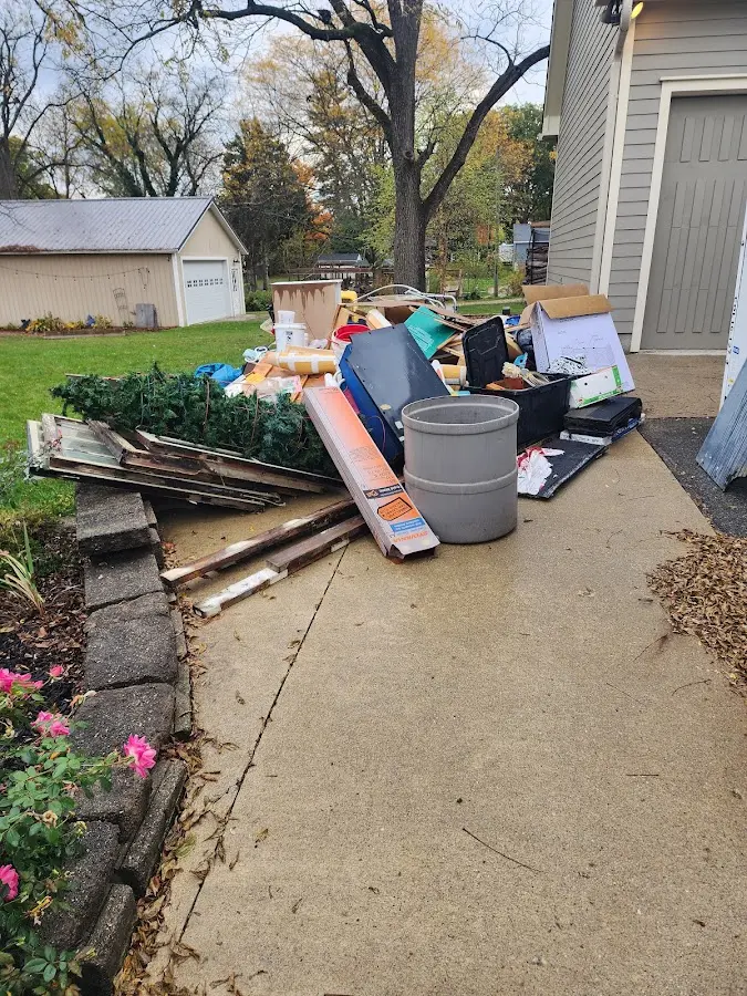 Dumpster being loaded with debris for 12 Yard Dumpster Rental in Willow Springs